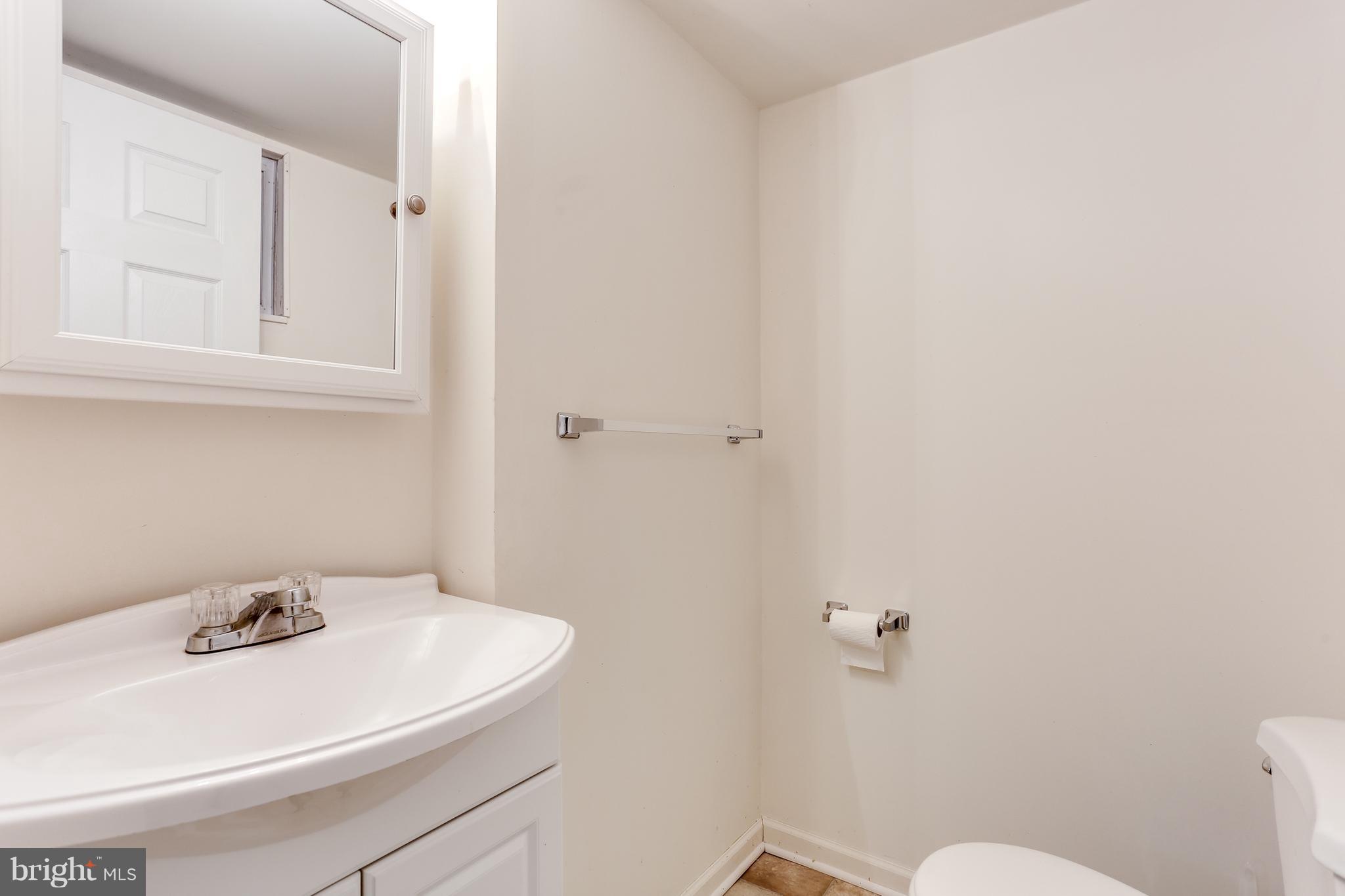 12714 Helen Road Silver Spring, MD 20906 - Photo 16 of 19 a bathroom with a sink a toilet and vanity