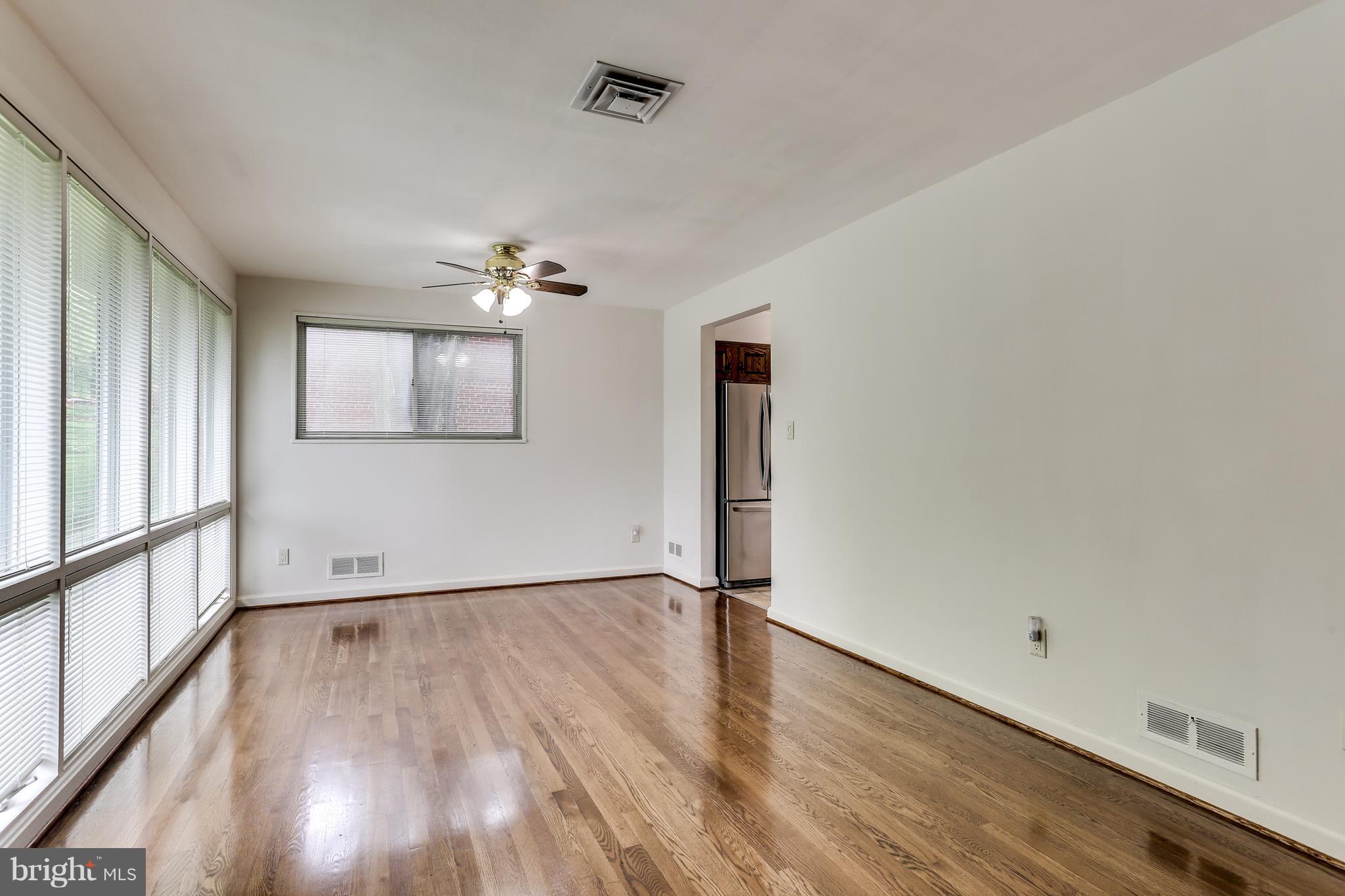 12714 Helen Road Silver Spring, MD 20906 - Photo 4 of 19 a view of an empty room with wooden floor and a window