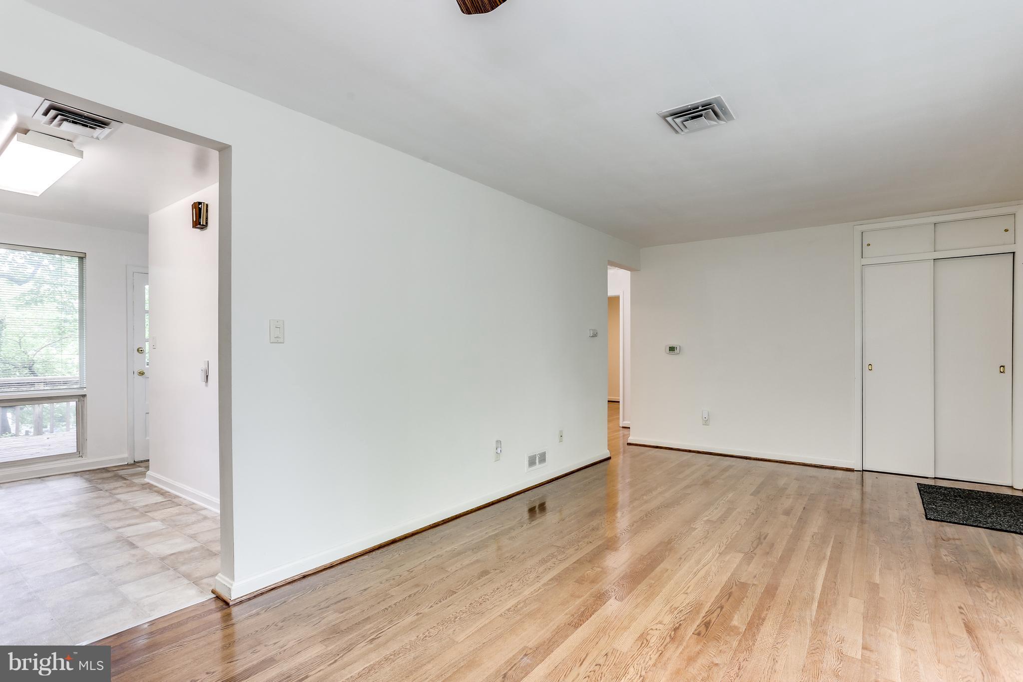 12714 Helen Road Silver Spring, MD 20906 - Photo 5 of 19 an empty room with wooden floor and windows