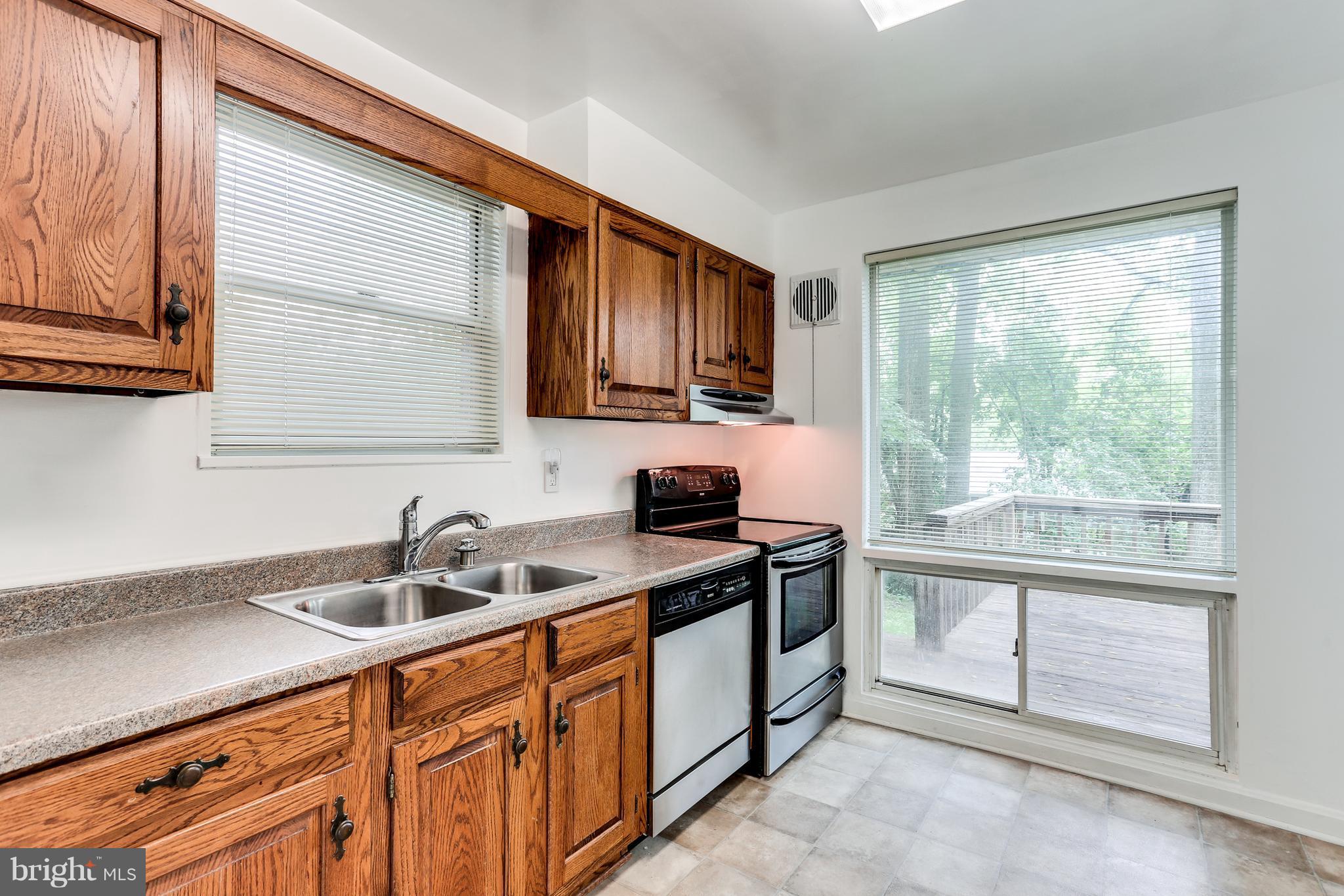12714 Helen Road Silver Spring, MD 20906 - Photo 7 of 19 a kitchen with stainless steel appliances granite countertop a sink stove and cabinets