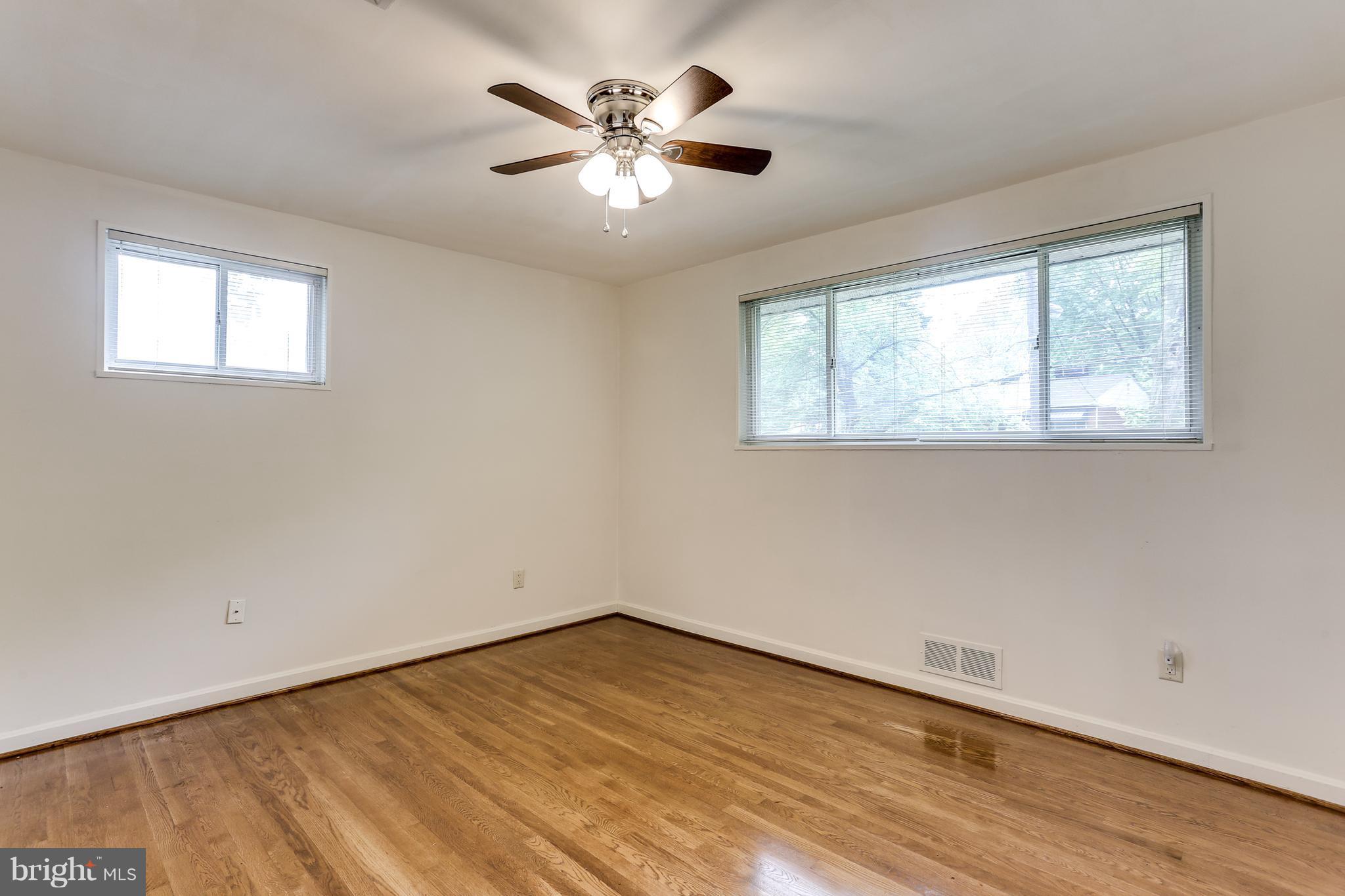 12714 Helen Road Silver Spring, MD 20906 - Photo 9 of 19 an empty room with wooden floor and windows