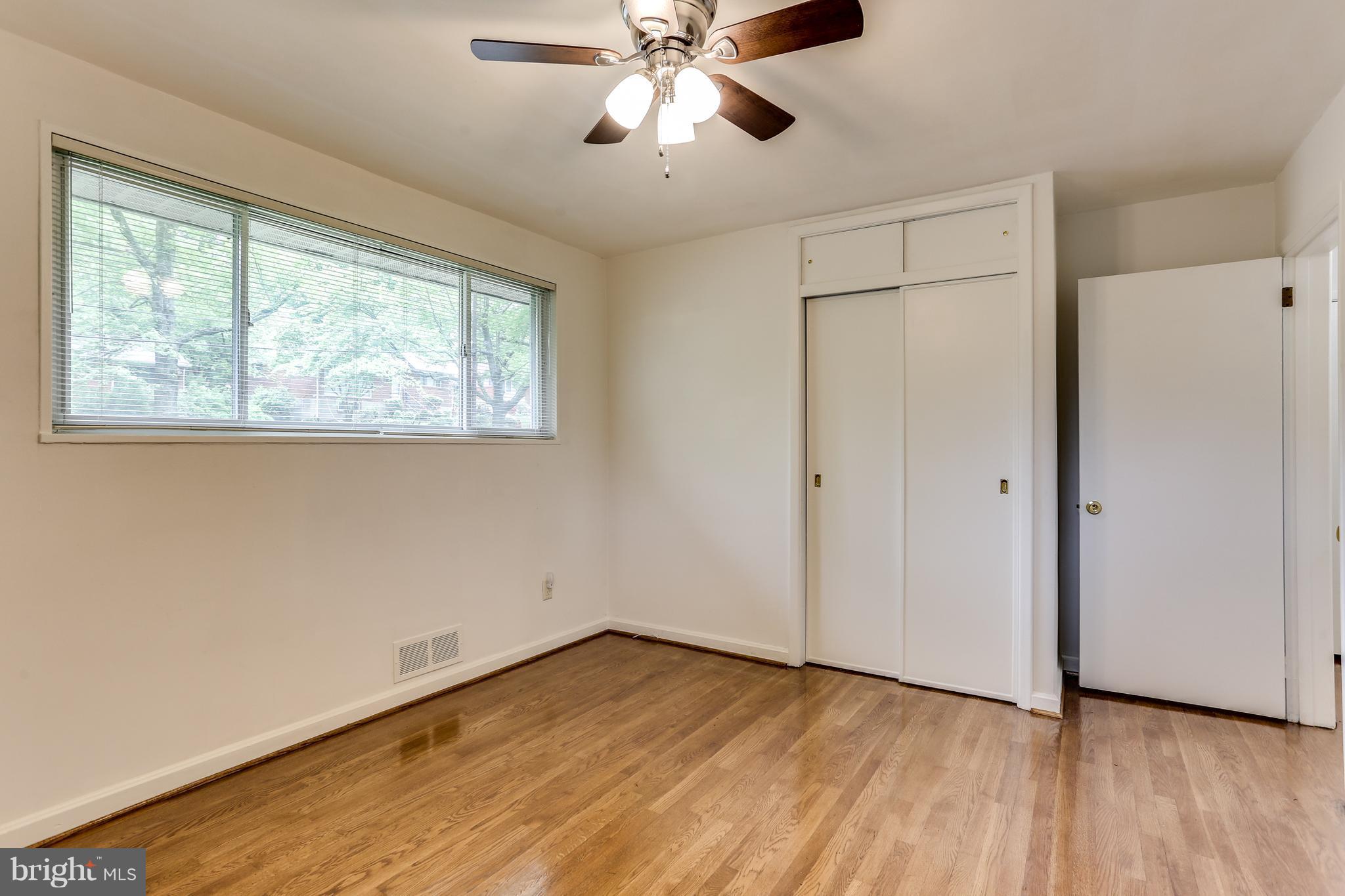 12714 Helen Road Silver Spring, MD 20906 - Photo 10 of 19 a view of an empty room with wooden floor and a window