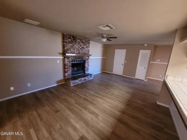 wooden floor in an empty room with a fireplace