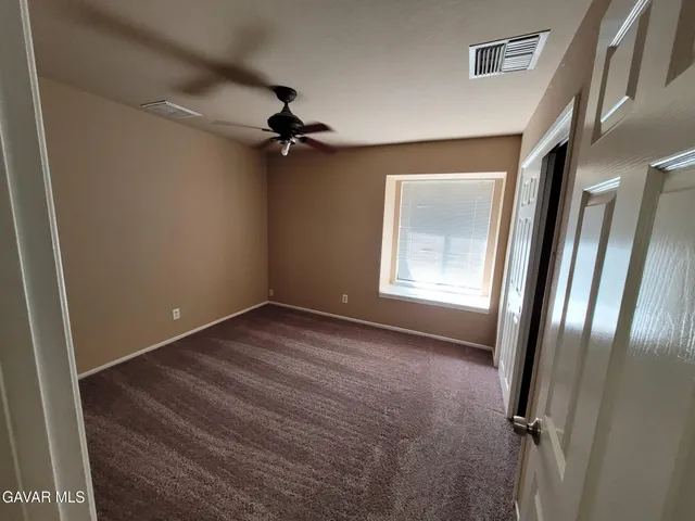 a view of a room with a wooden floor