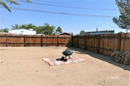 744 West Reeves Avenue Ridgecrest, CA 93555 - Photo 22 of 26 a swimming pool with wooden fence