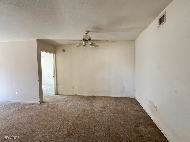 8070 West Russell Road, Unit 2068 Las Vegas, NV 89113 - Photo 3 of 7 Unfurnished room featuring visible vents, a ceiling fan, and carpet
