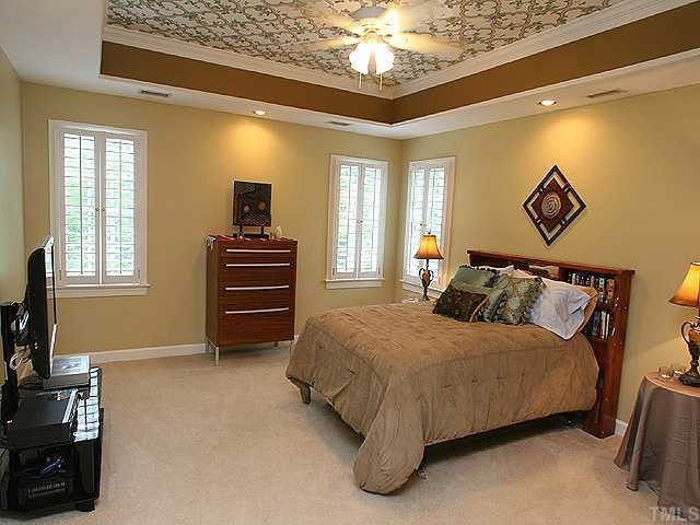 2332 Primrose Valley Court Raleigh, NC 27613 - Photo 8 of 12 The luxurious owners suite has a trey ceiling, walk-in-closet, bathroom with tile flooring, whirlpool tub, his/hers vanities, and a private office/nursery/exercise room.