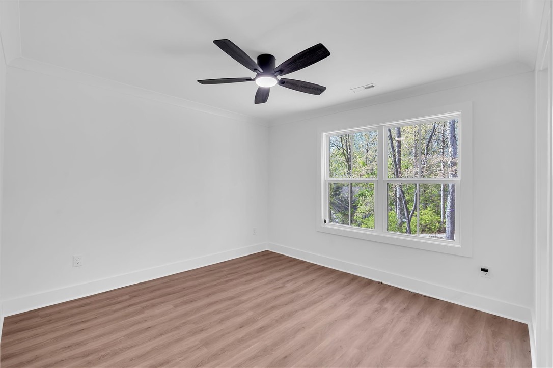 407 Blue Ridge Court Westminster, SC 29693 - Photo 31 of 48 Bright room with expansive windows offering serene outdoor views and durable flooring.