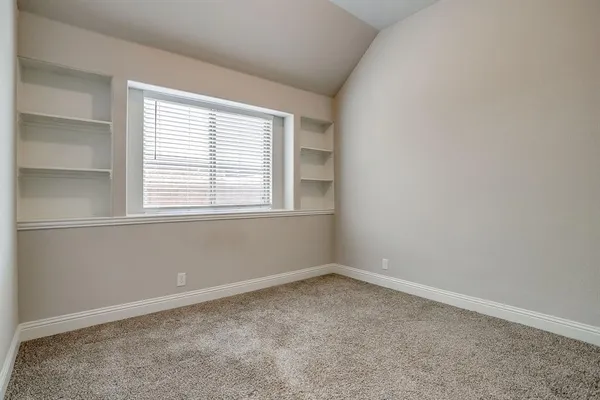 a view of a yard with a wooden fence
