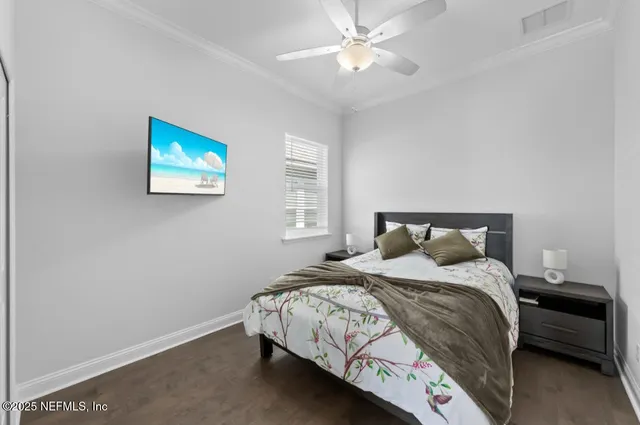 a bedroom with a bed and a painting on the wall