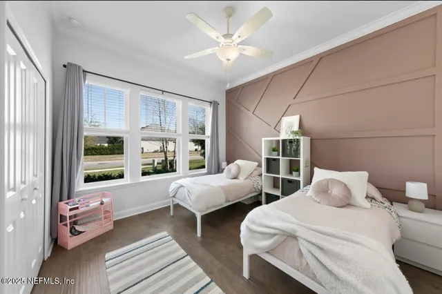 a bedroom with two beds and a large window with outer view