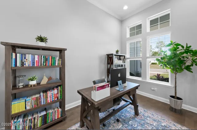 a living room with furniture and a book shelf