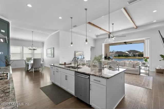 a living room with stainless steel appliances kitchen island a large island in the center