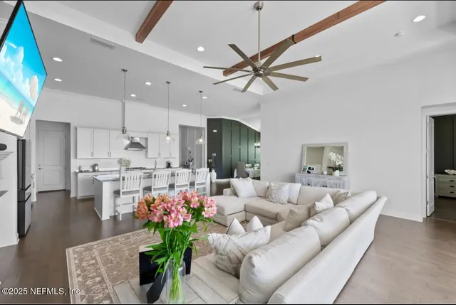 a living room with furniture and a chandelier