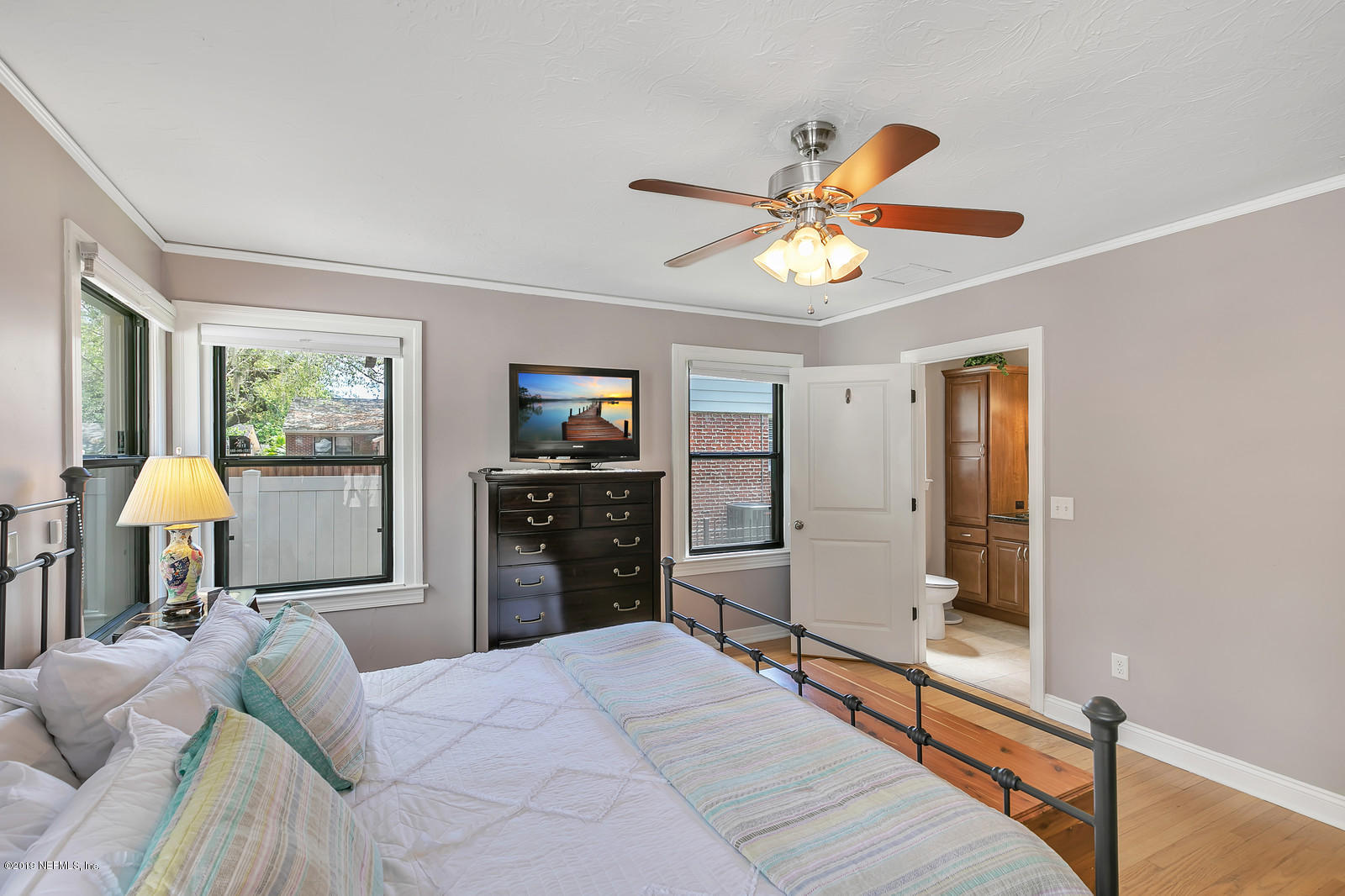 1425 Nicholson Road Jacksonville, FL 32207 - Photo 22 of 45 a bedroom with a bed and a chandelier
