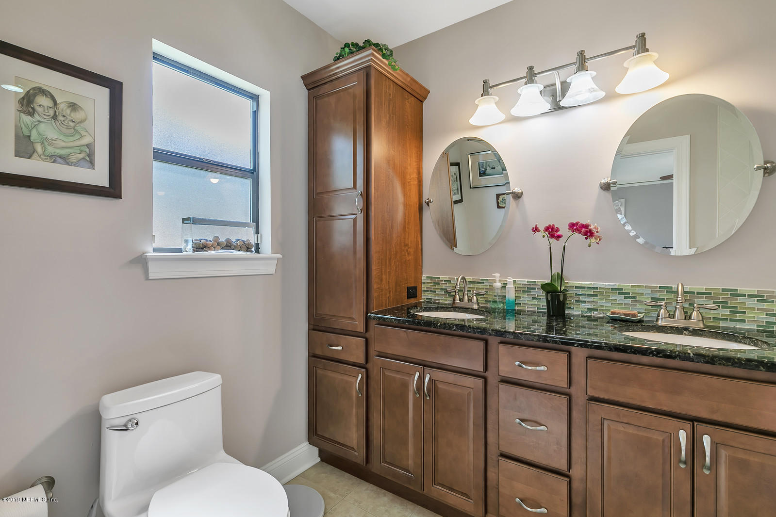 1425 Nicholson Road Jacksonville, FL 32207 - Photo 26 of 45 a bathroom with a toilet sink and mirror