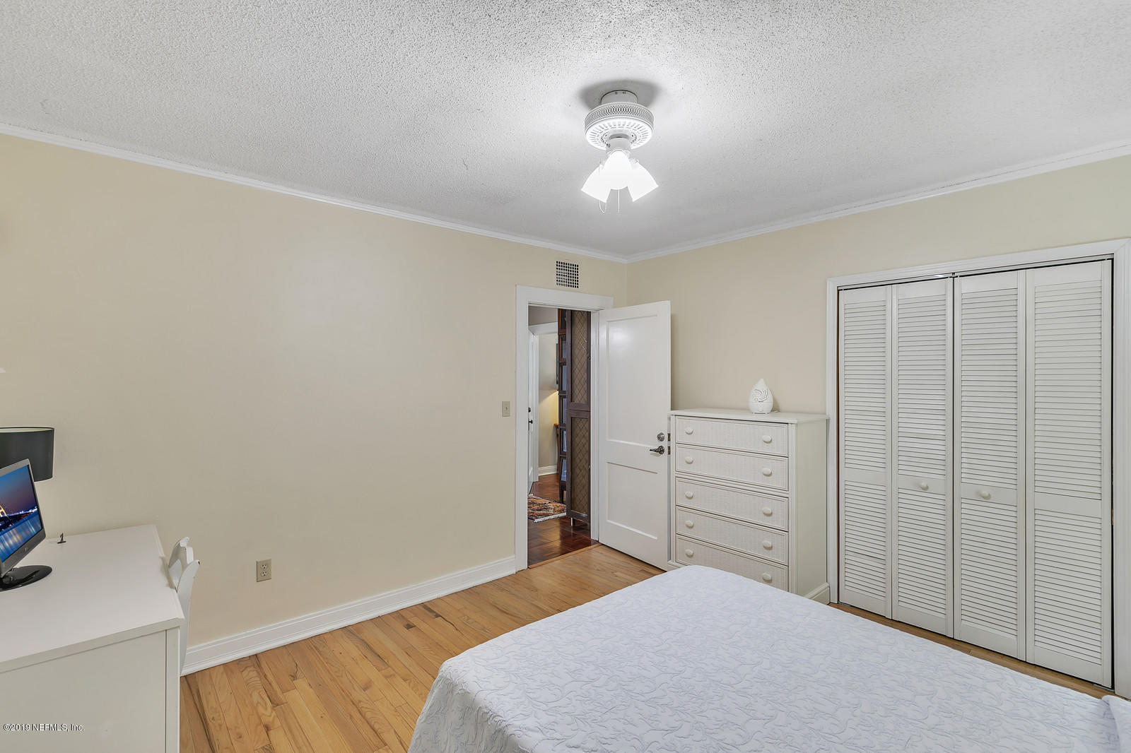 1425 Nicholson Road Jacksonville, FL 32207 - Photo 30 of 45 a bedroom with a bed and cabinets