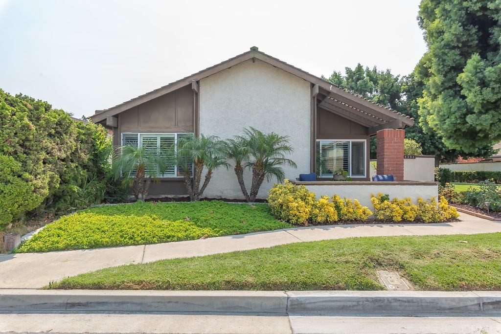 14302 Raintree Road Tustin, CA 92780 - Photo 1 of 1 a front view of a house with a yard