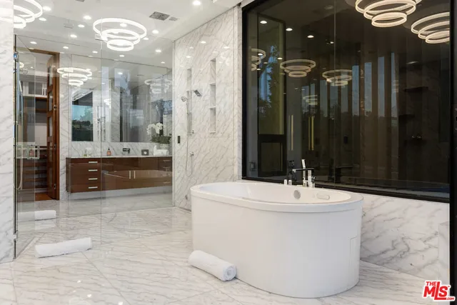 a large bathroom with a glass shower door and a shower