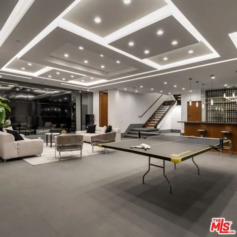 a kitchen with stainless steel appliances granite countertop a sink a stove and a wooden floors