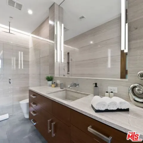 a bedroom with a bed and a chair