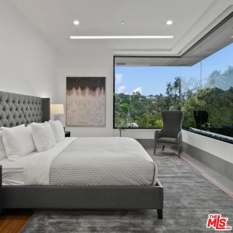 a large bedroom with a large bed and a large window