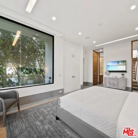 a bedroom with a bed and window