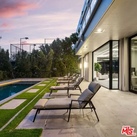 a swimming pool view with a seating space