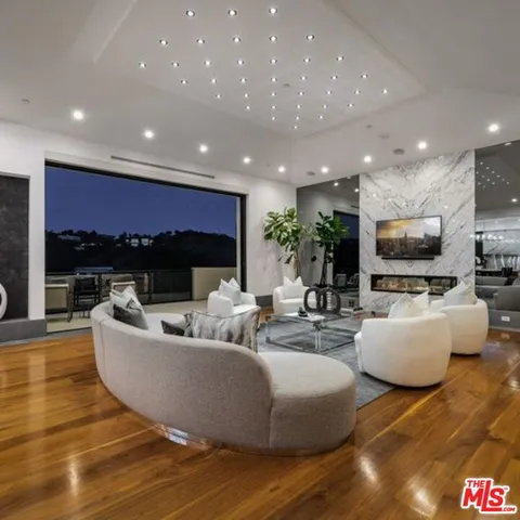a living room with furniture and a large pool