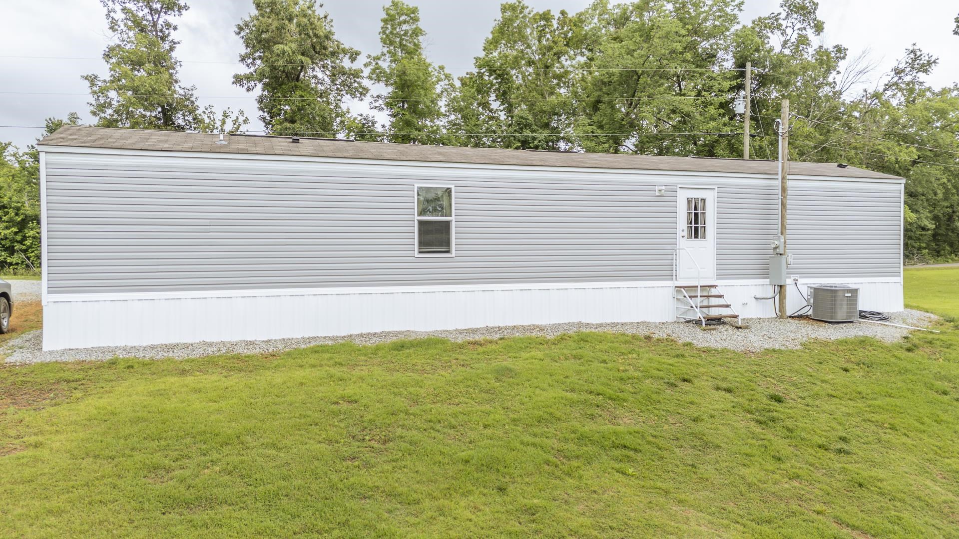 3275 Glendale Road Adamsville, TN 38310 - Photo 7 of 39 a view of a backyard with plants and large tree