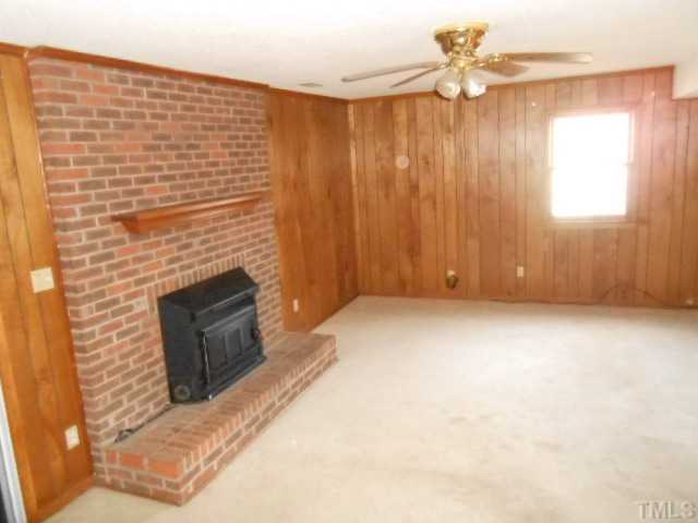 4700 Waterbury Road Raleigh, NC 27604 - Photo 5 of 9 a view of an empty room with a fireplace