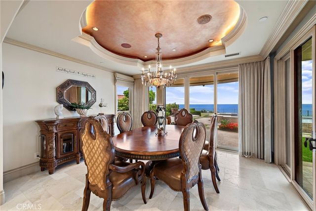 a view of a dining room with furniture and chandelier