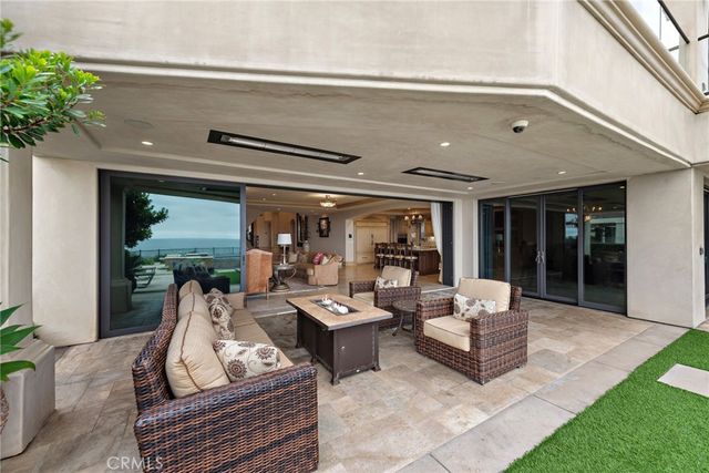 a balcony with table and chairs