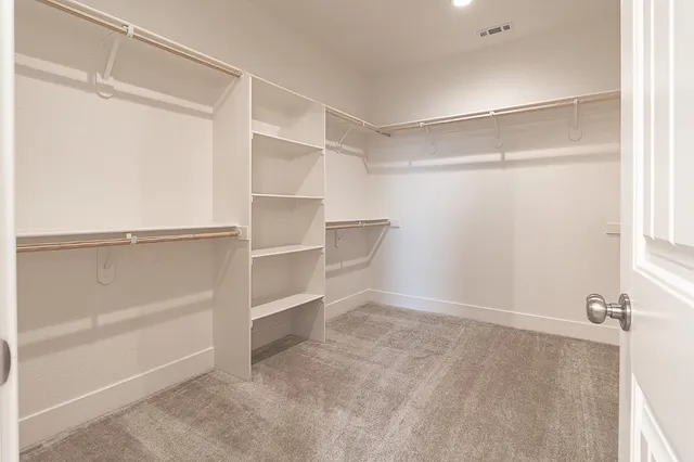 an empty room with a ceiling fan and a window