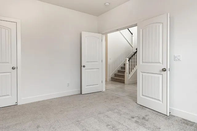 a view of an empty room with stairs