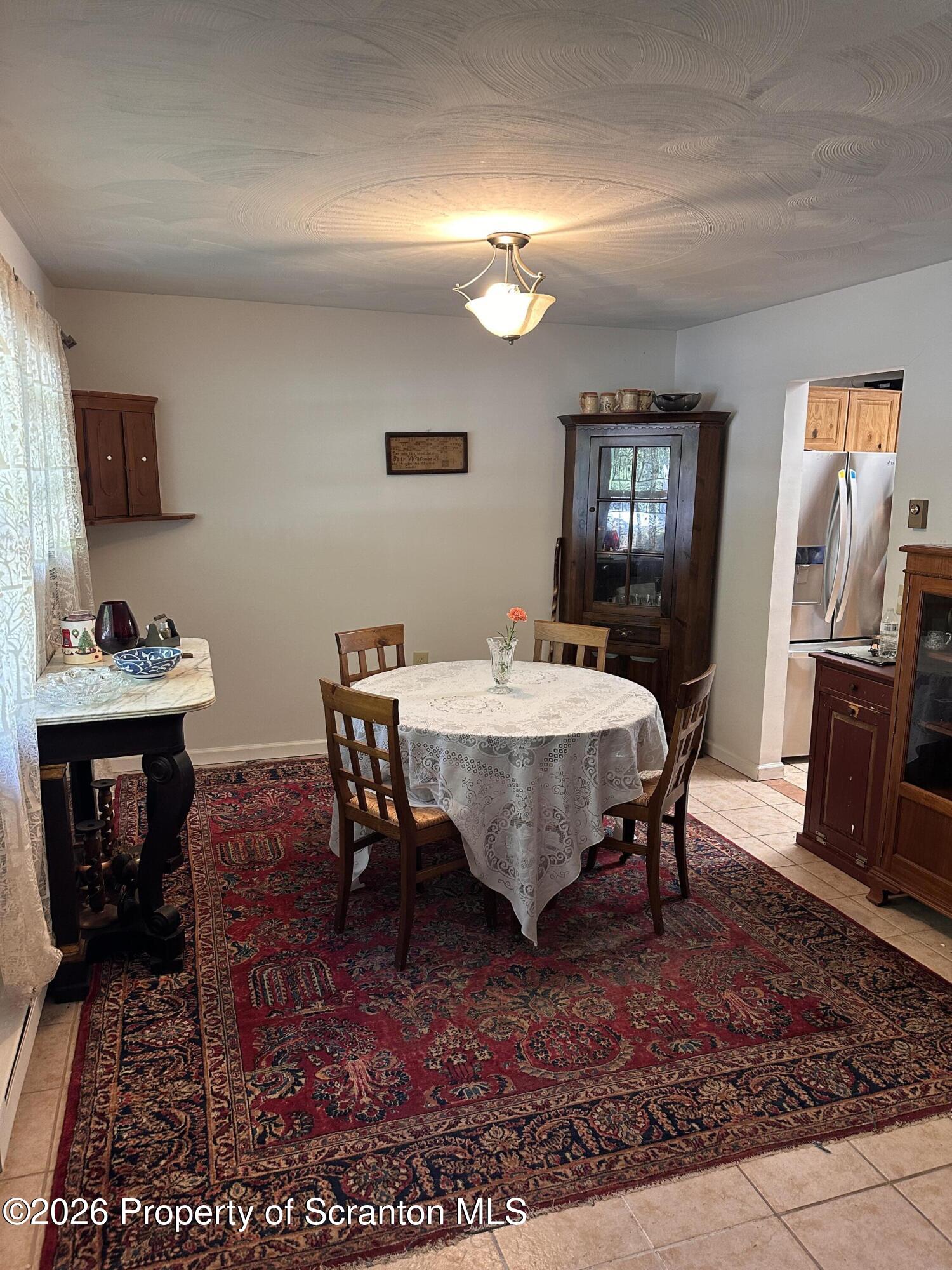 107 Keystone Hls Road, Unit 405 Factoryville, PA 18419 - Photo 9 of 27 a view of a dining room with furniture and wooden floor