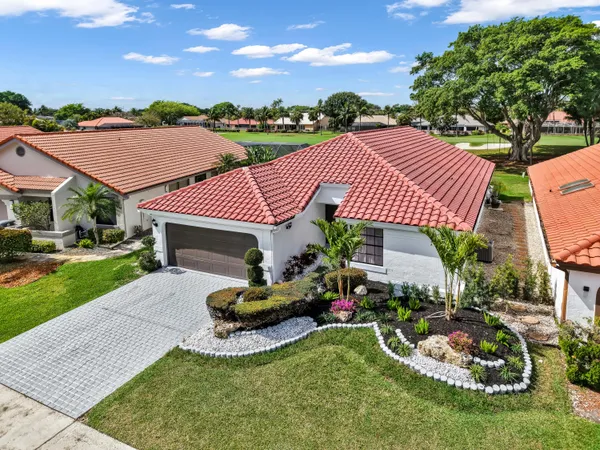 a aerial view of a house with swimming pool garden and outdoor seating