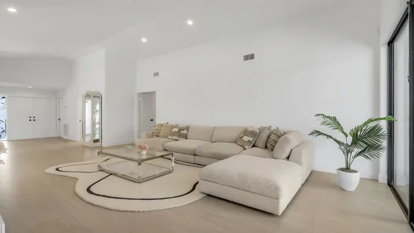 a living room with furniture and a potted plant