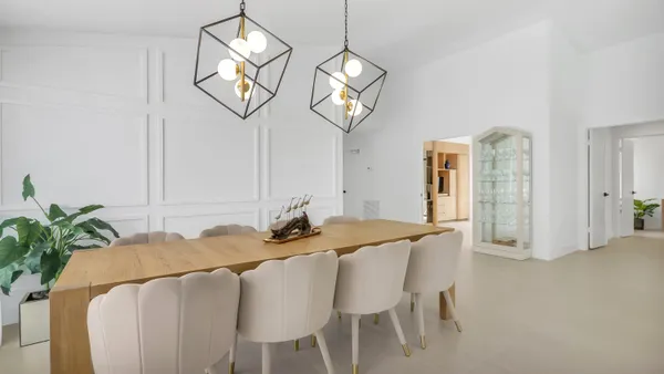 a view of a dining room with furniture and chandelier
