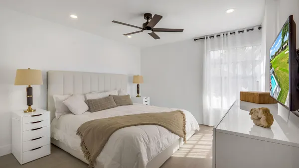 a bedroom with a bed a window and a couch