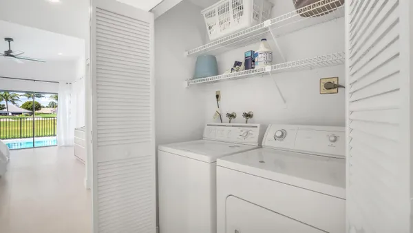 a utility room with cabinets washer and dryer