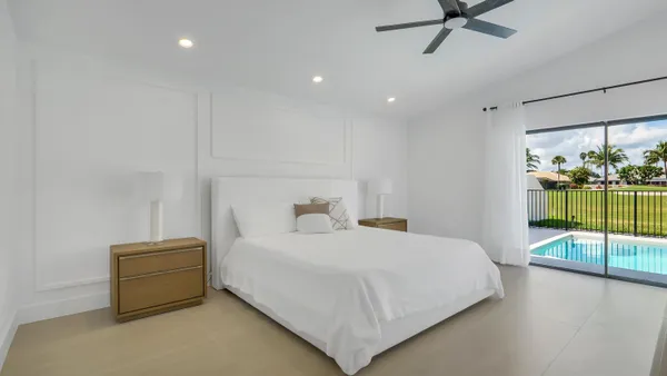 a bedroom with a bed and glass door