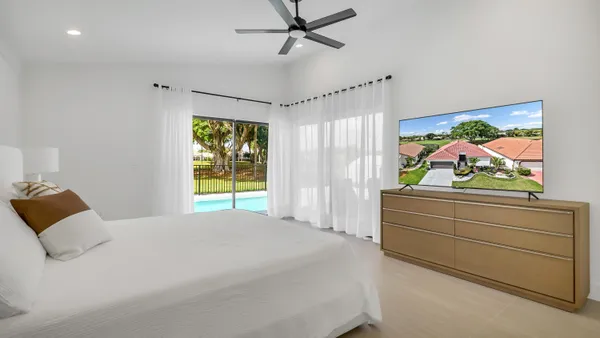 a bedroom with a bed and a painting on the wall