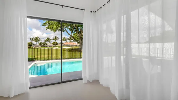 a view of an empty room with a floor to ceiling window