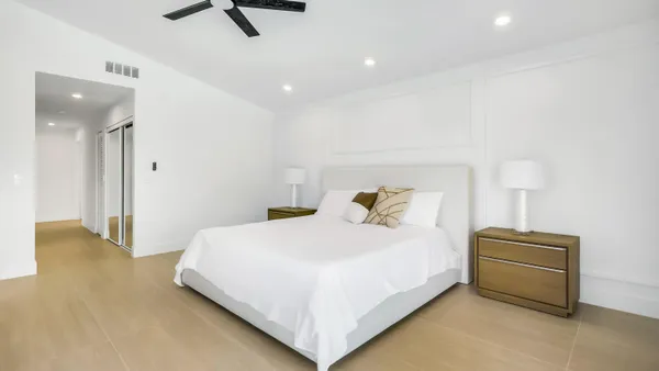 a bedroom with a bed and a chandelier