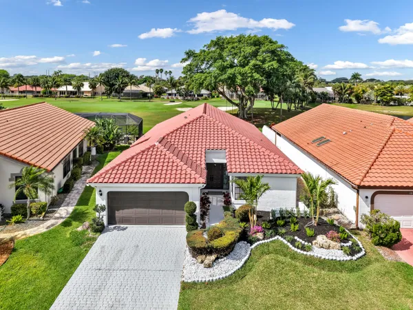 a view of a patio with chair and tables back yard of the house