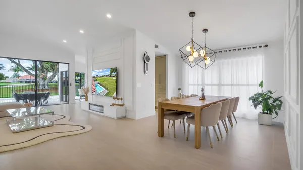 a dining room with furniture garden view and a chandelier