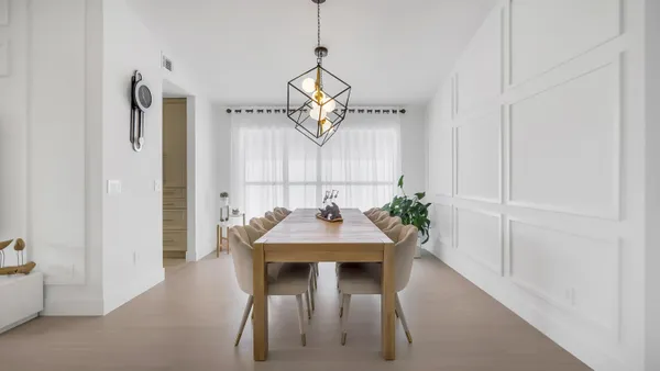 a view of a dining room with furniture and a chandelier