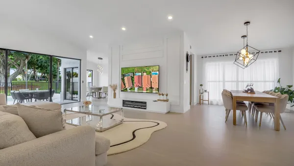 a living room with fireplace furniture and a large window