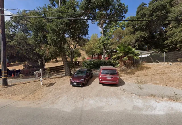 a view of a yard with large trees